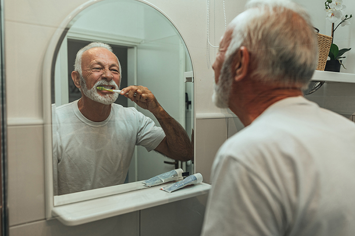 man and woman brushing teeth